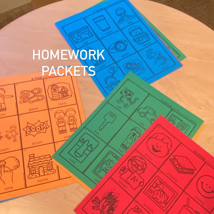 Colorful speech homework packets with articulation picture cards on a table.